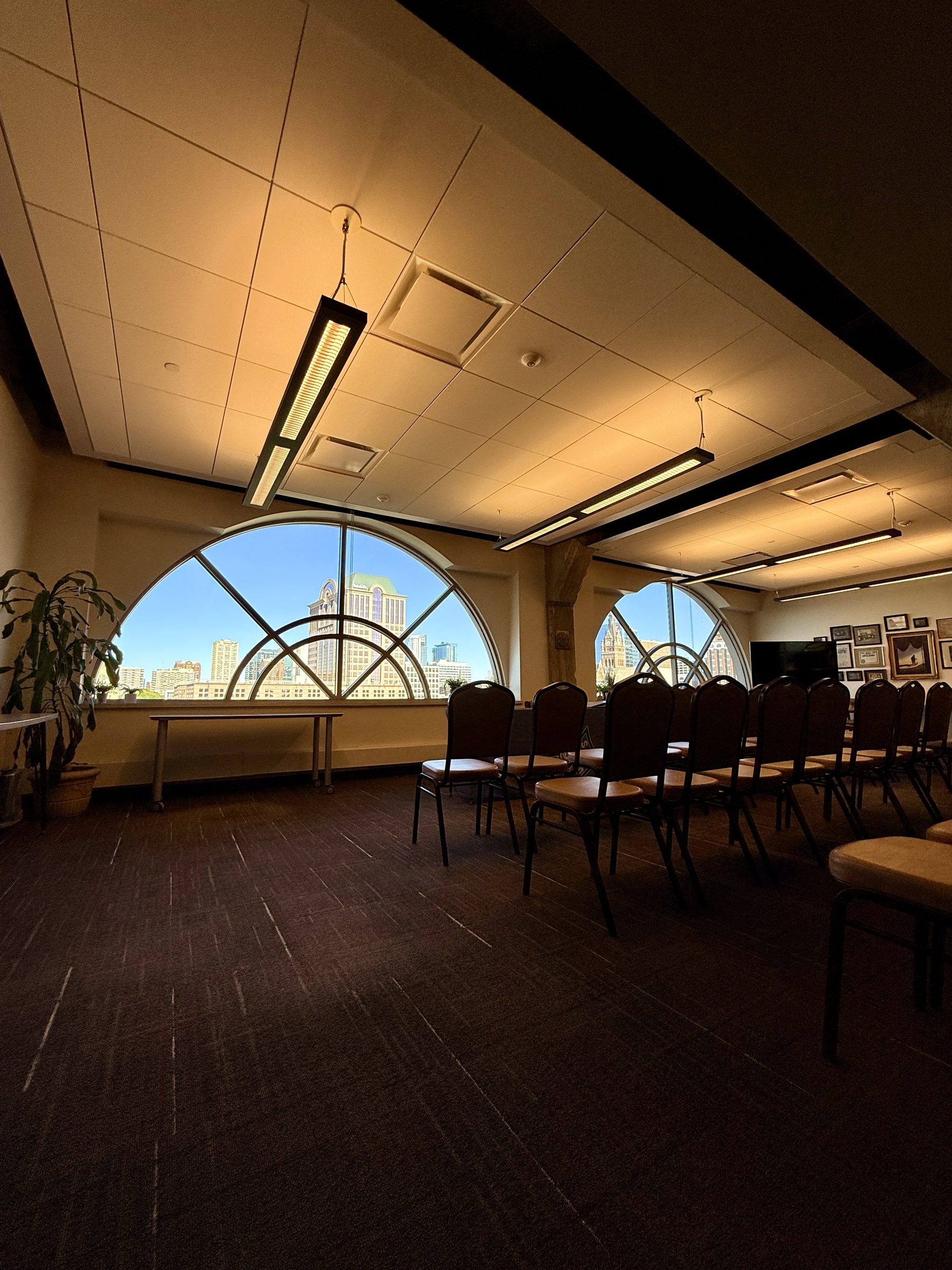 A common area at Riverfront Plaza, arched windows looking out over downtown Milwaukee